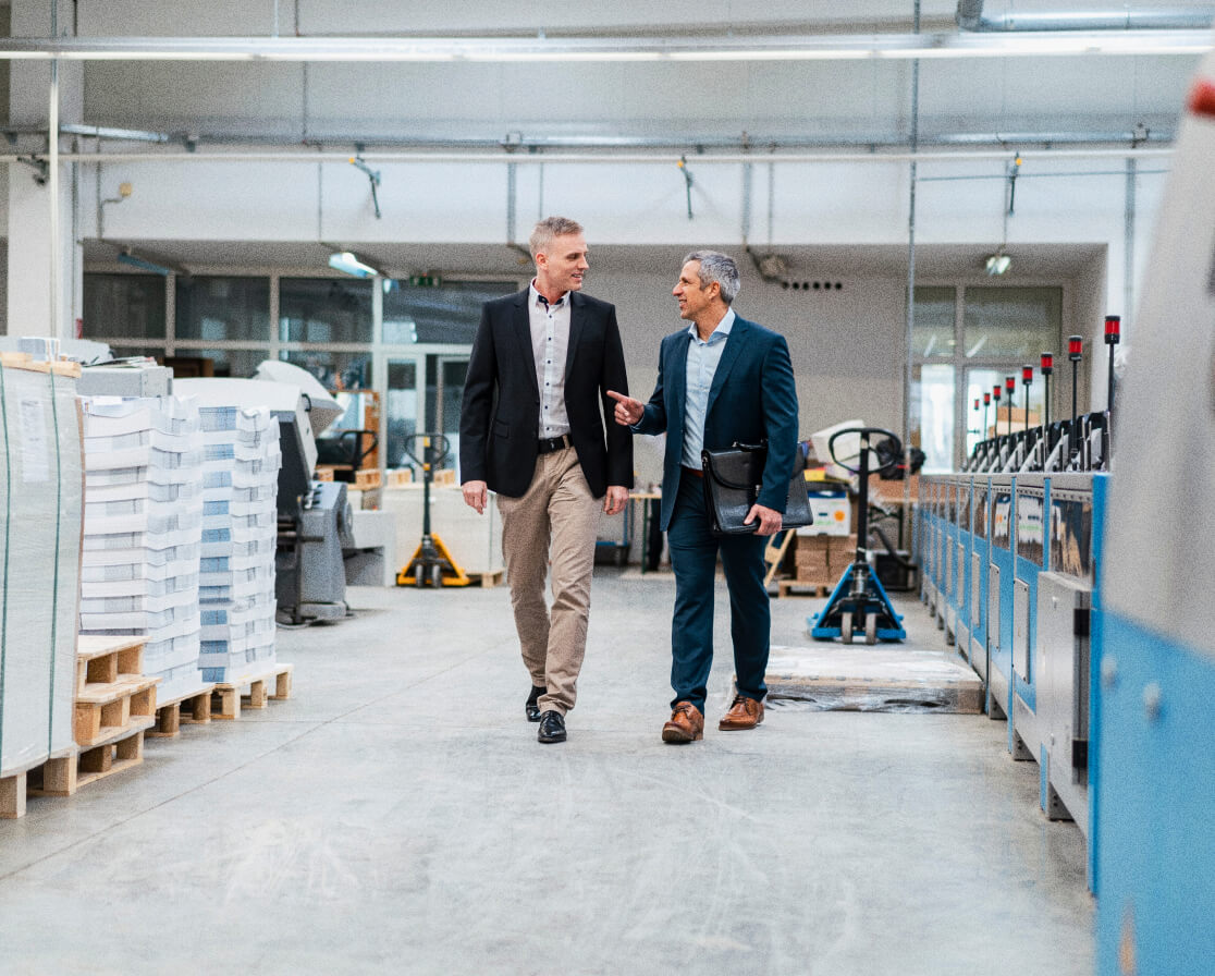 two business partners walking through warehouse